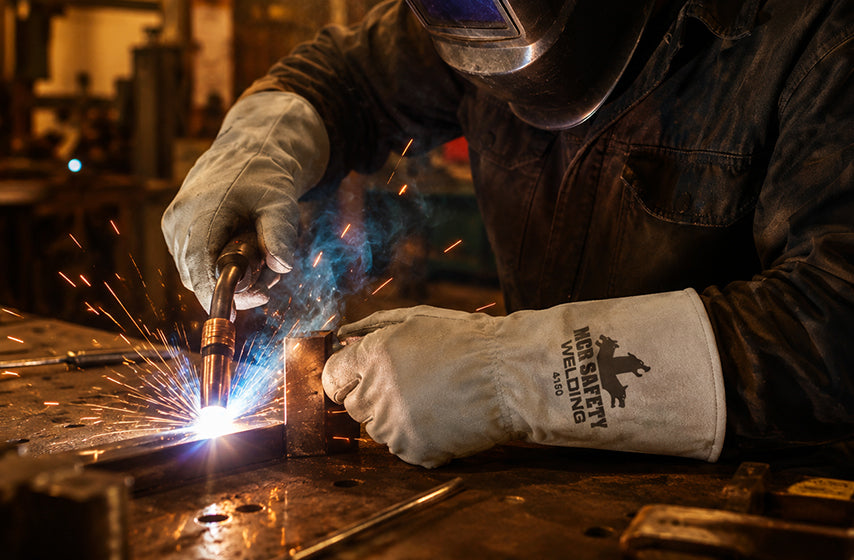 Welding gloves providing hand protection from heat, sparks, and abrasion